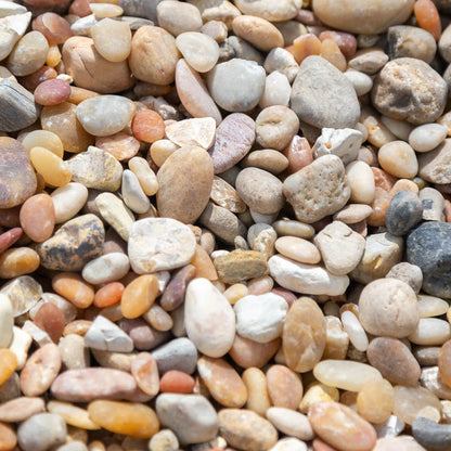 Sample 4 of Alabama sunset river rock gravel for sale with a concentration of various shades of cream, tan, yellow and orange
