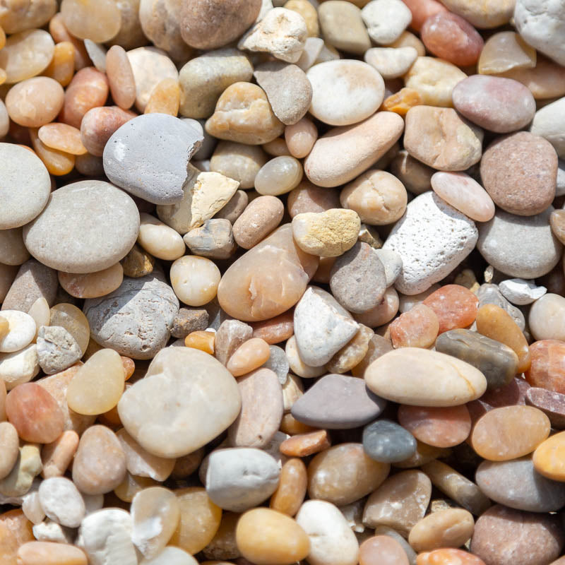 Sample 5 of Alabama sunset river rock gravel for sale with a concentration of various shades of cream, tan, yellow and orange