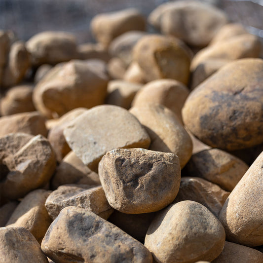 Close-up of a pile of brown stones small brown boulders for sale in jacksonville fl 