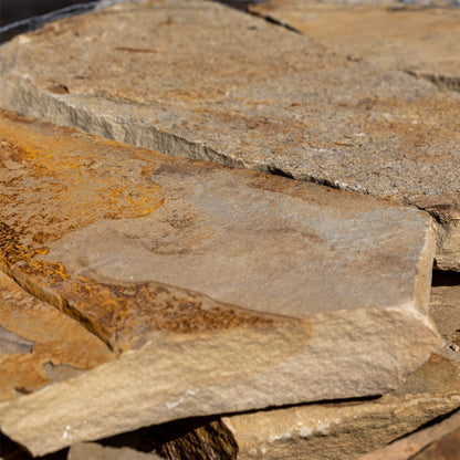 Close-up of stacked stone slabs with natural textures and colors.