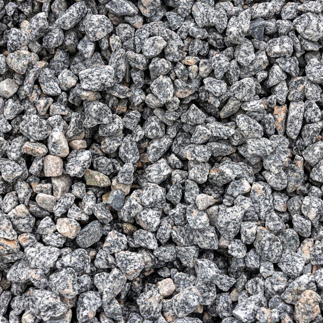 Gray and black granite decorative gravel stones with natural speckled texture filling the frame.