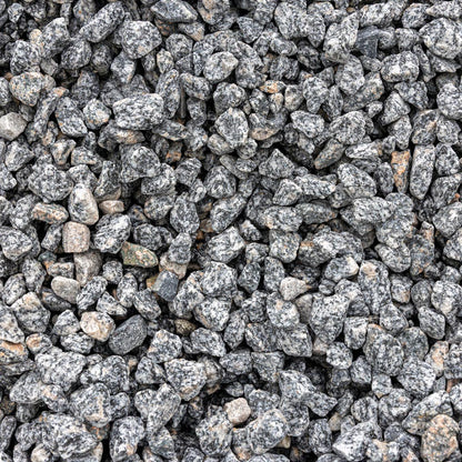 Gray and black granite decorative gravel stones with natural speckled texture filling the frame.