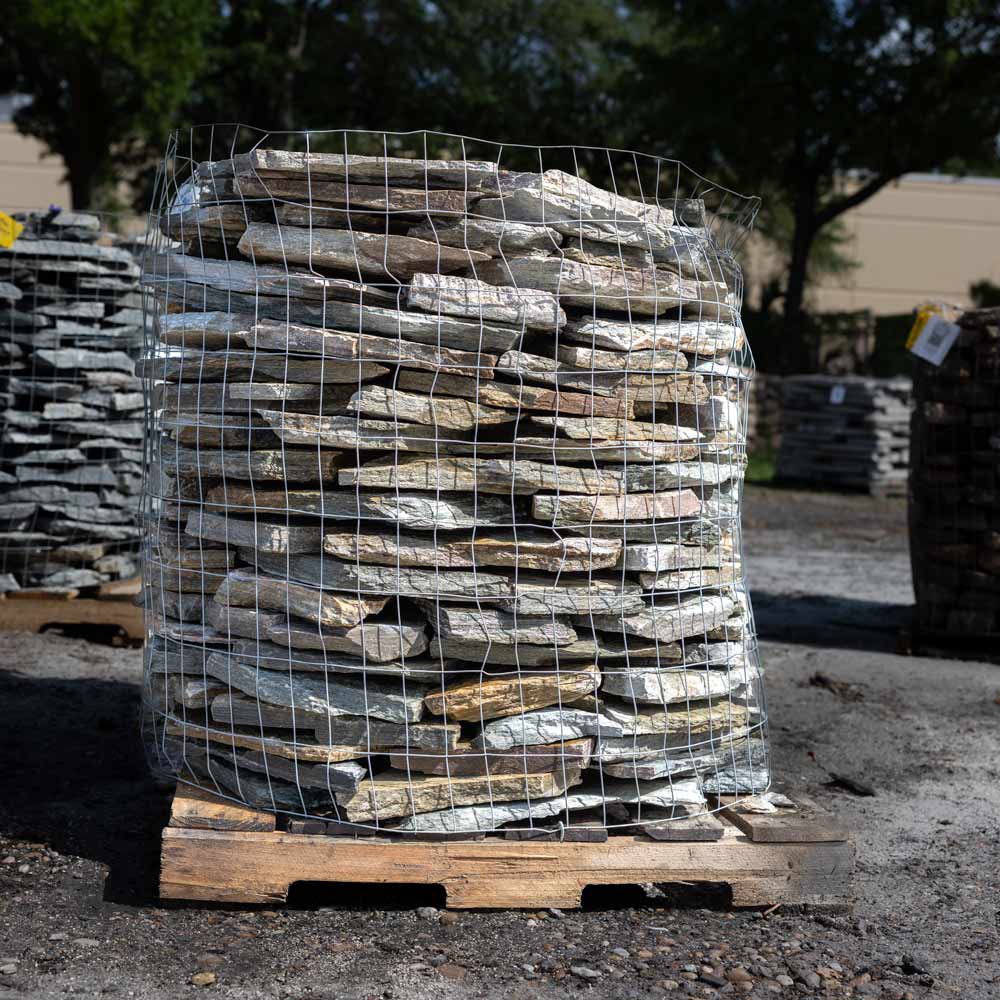 Stack of stones in a wire cage on a pallet outdoors