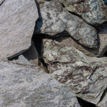 Close-up of a stone wall with gray and brown stones
