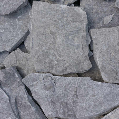 Close-up of gray stone tiles with a rough texture.